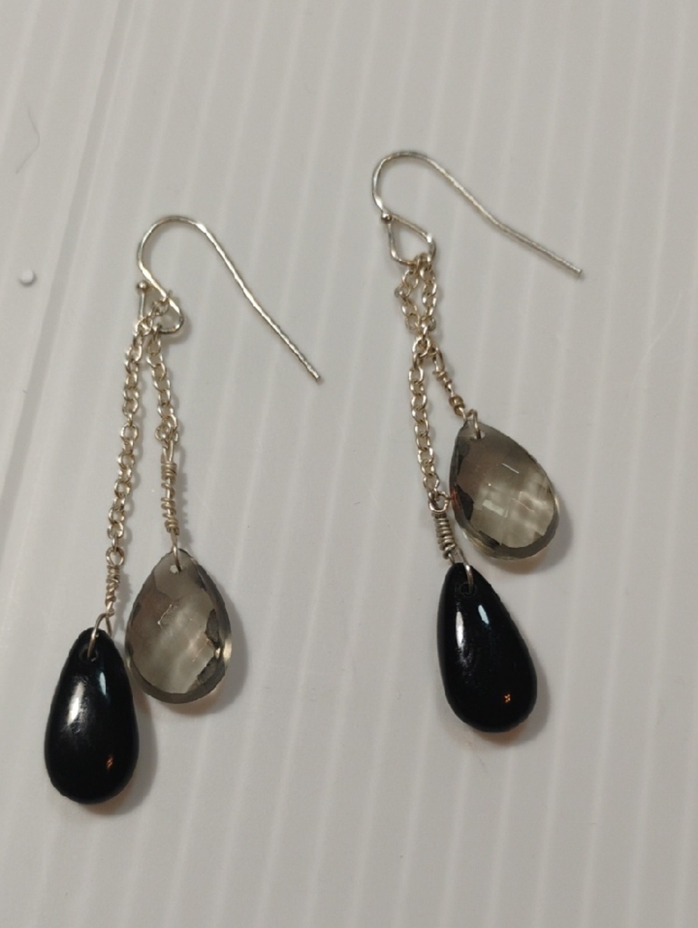 silver dangle earrings featuring faceted black crystal teardrops & smokey accent